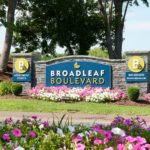 Broadleaf Boulevard entrance sign fitted with flowers, and lighting.